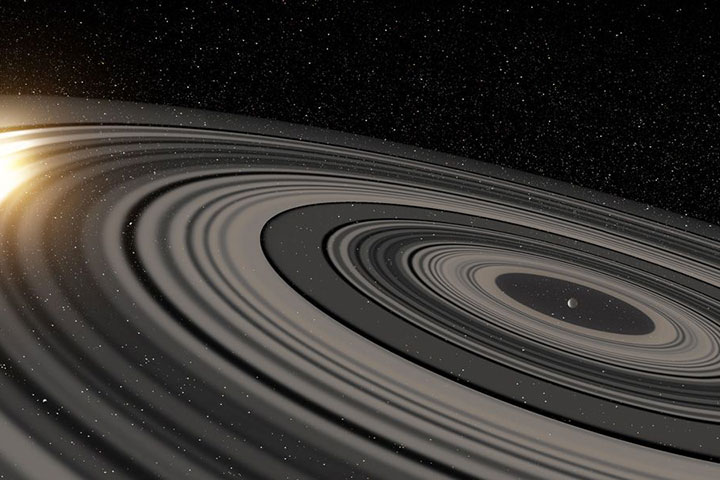 Vue d'artiste des anneaux gravitant autour d'un corps, probablement une naine brune.