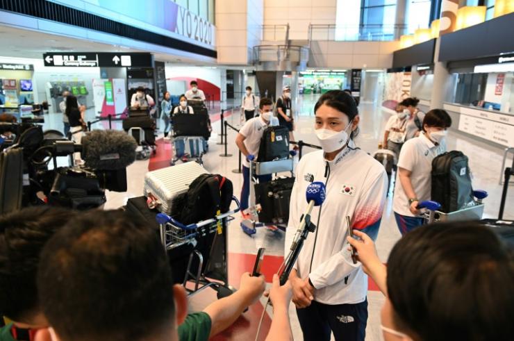 La volleyeuse sud-coréenne Kim Yeon-koung interviewée par des journalistes lors de son arrivée à l'aéroport de Narita le 20 juillet 2021, avant le début des JO de Tokyo © AFP/Archives Kazuhiro Nogi