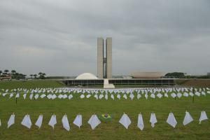 Des militants accrochent des mouchoirs blance en hommage aux morts du Covid, devant le Congrès national du Brésil, à Brasilia, le 18 octobre 2021. © AFP EVARISTO SA